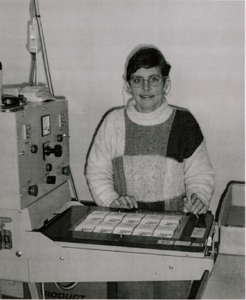 Employee with a disability using a sewing machine in the warehouse 